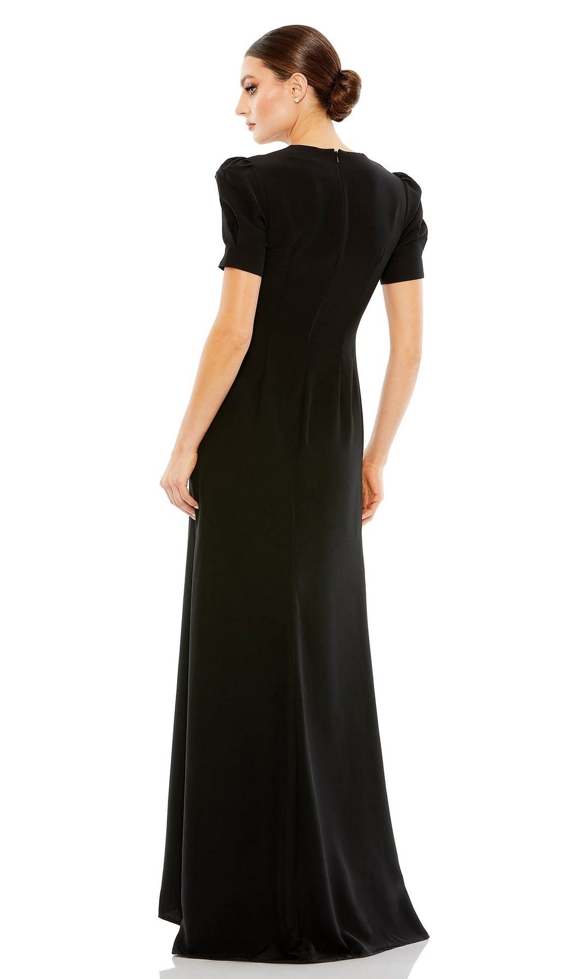 A woman faces away, wearing the Mac Duggal 2630 Short-Sleeve Long Formal Dress in black, featuring a smooth, fitted silhouette.